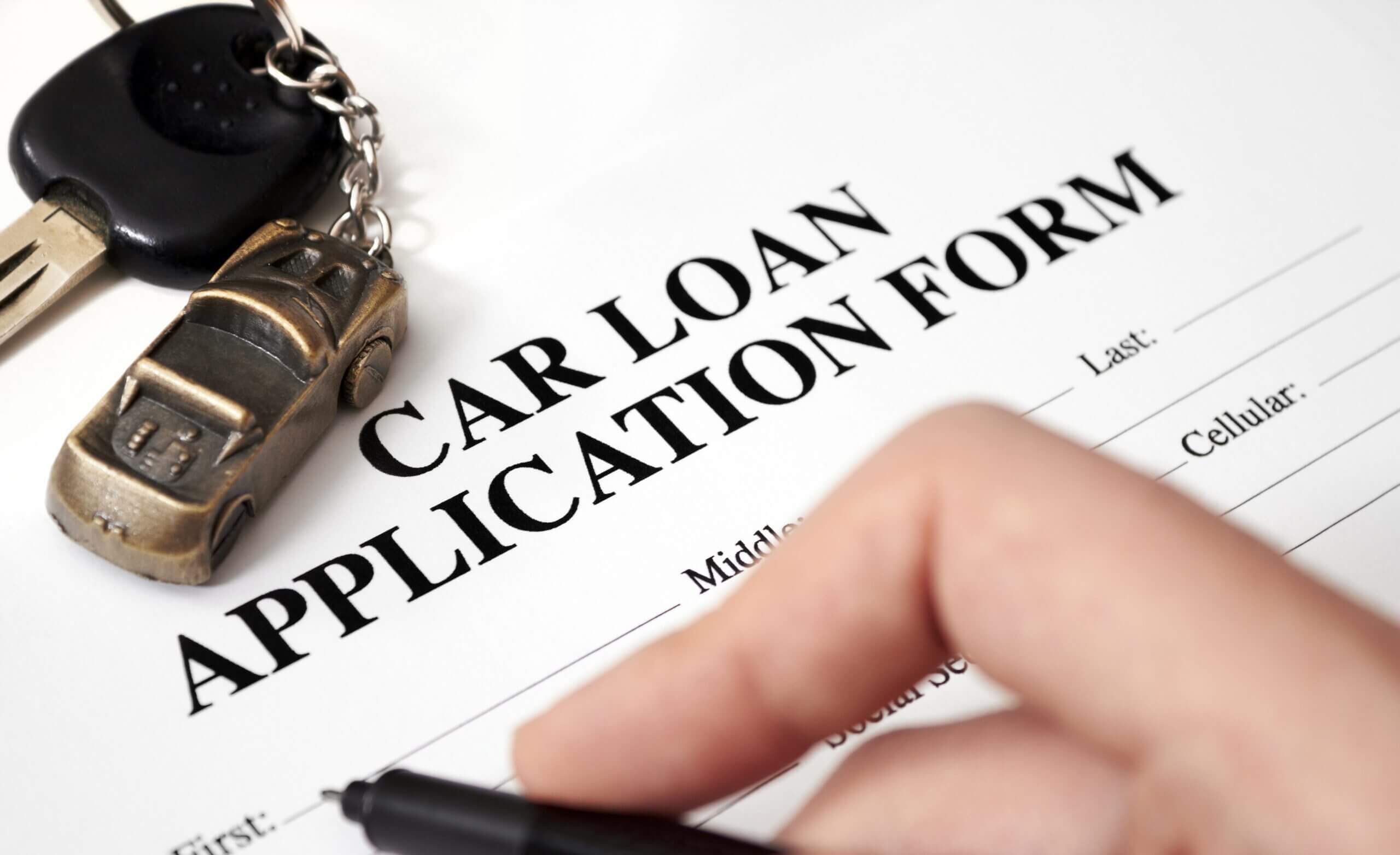 a person filling out a car loan application form