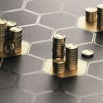 Abstract gold metallic discs stacked across a dark, interconnected hexagonal grid, illustrating a dynamic and structured financial strategy.