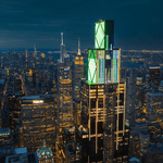 JPMorgan Chase headquarters, stands illuminated at night above Midtown Manhattan in New York City