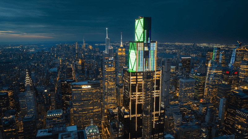 JPMorgan Chase headquarters, stands illuminated at night above Midtown Manhattan in New York City