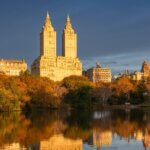 New York City skyline and fall foliage reflecting in water for the October financial market update