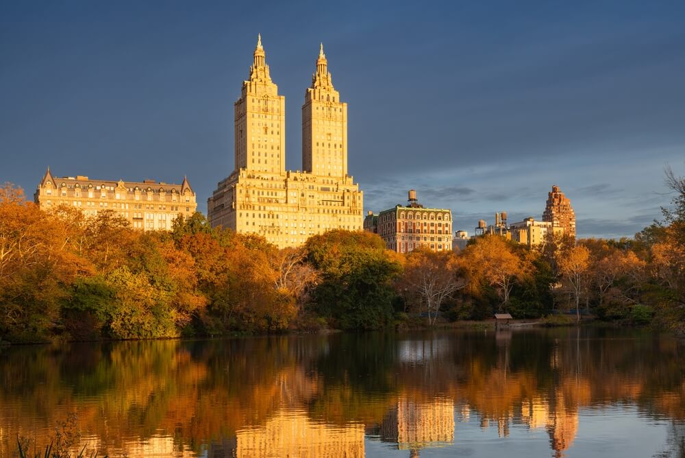 New York City skyline and fall foliage reflecting in water for the October financial market update
